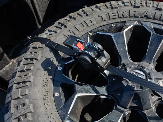 Ratchet strap securing a spare tyre in an off-road vehicle